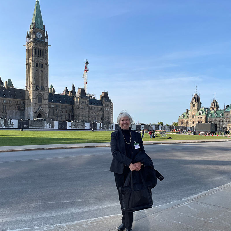 Cathy in front of Canada's Parliament Buildings
